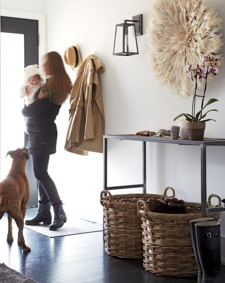 Woman with child and dog walking out the front door.