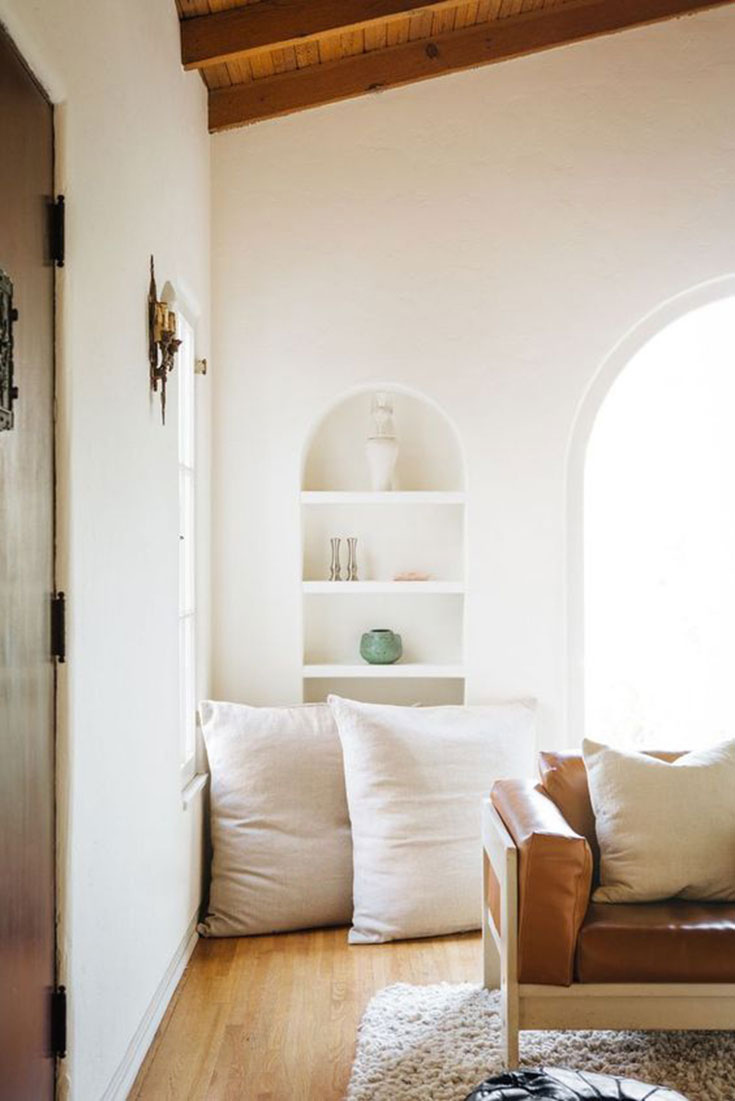 Beautiful linen pillows propped against the wall.