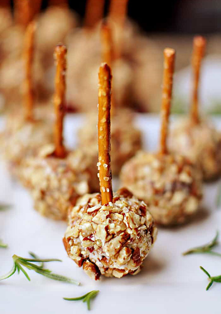 Mini Cheese Ball Bites are studded with dried cranberries and blue cheese, rolled in pecans, and skewered with pretzel sticks for fun, easy party appetizers!