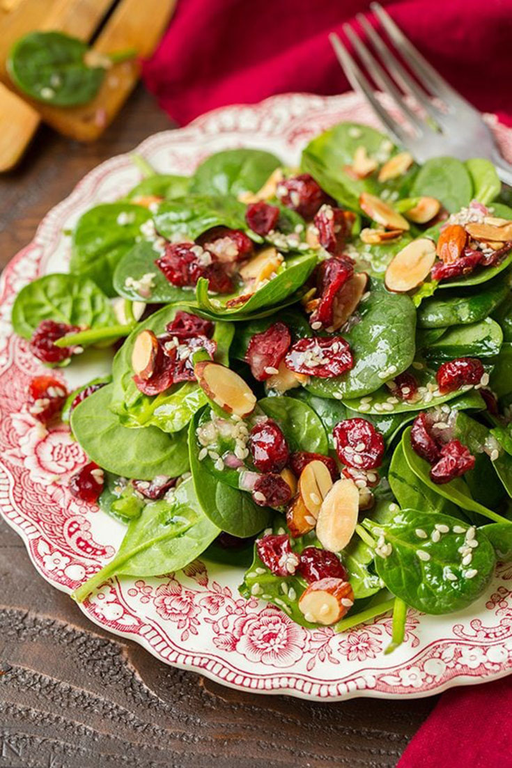 A festive red and green spinach salad. Sweet and savory, perfect for any holiday party.