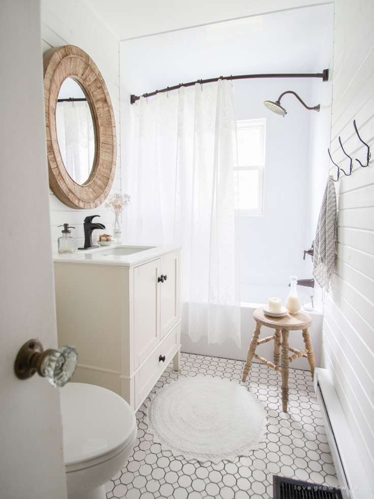 Simple white organized bathroom by Love Grows Wild.