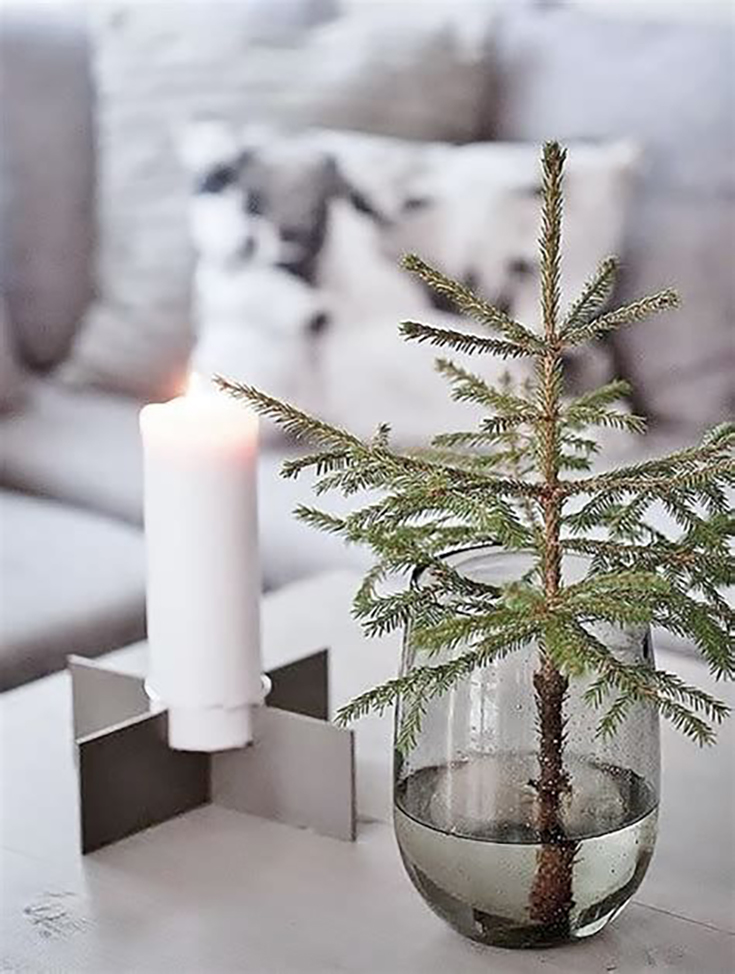 Pine branch on a table. Simple, Scandinavian inspired Christmas decor.