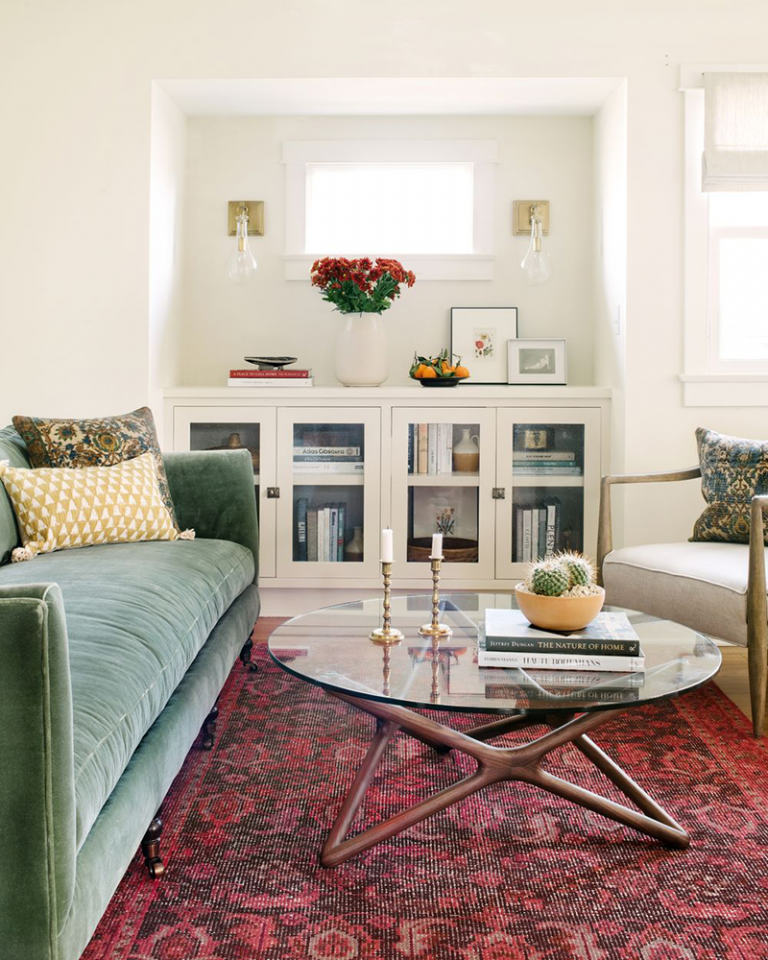 creamy-white-living-room-with-green-velvet-sofa-and-oriental-rug