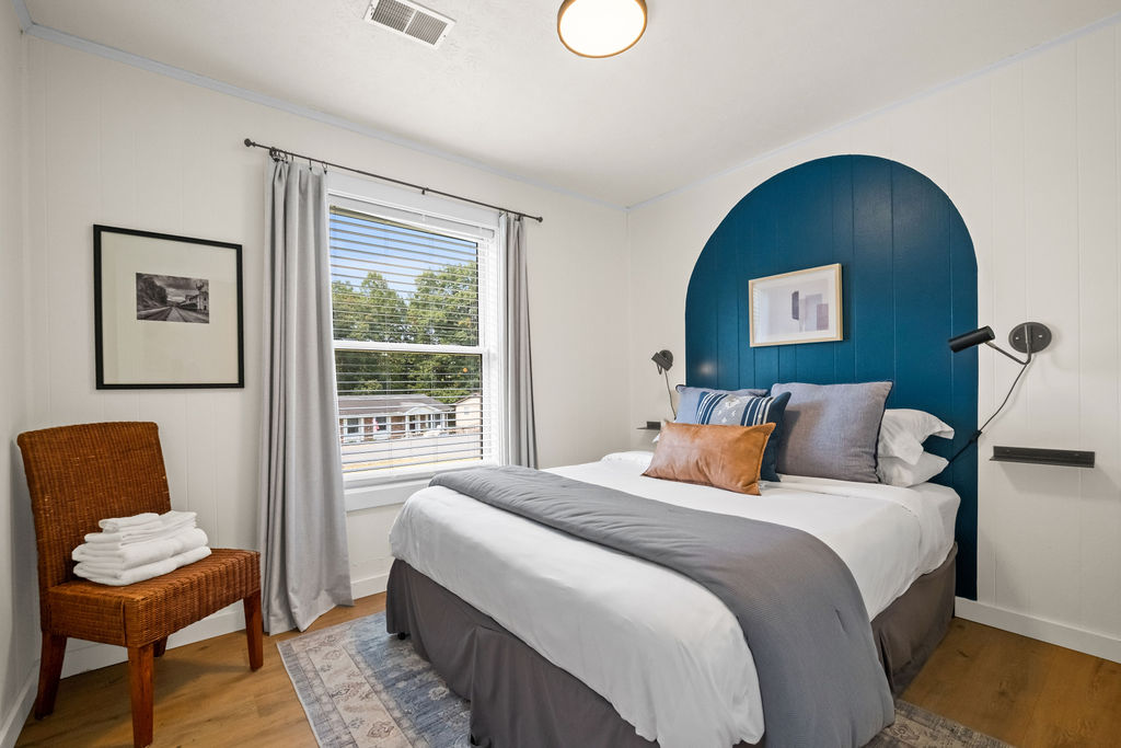 Gorge Getaway bedroom today with a blue painted arch behind the bed